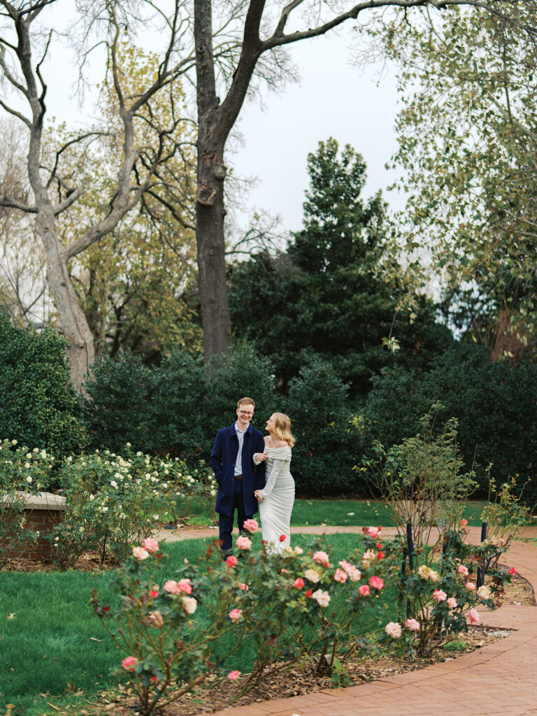 Sierra and Liam walking together during their Dallas Arboretum engagement photos