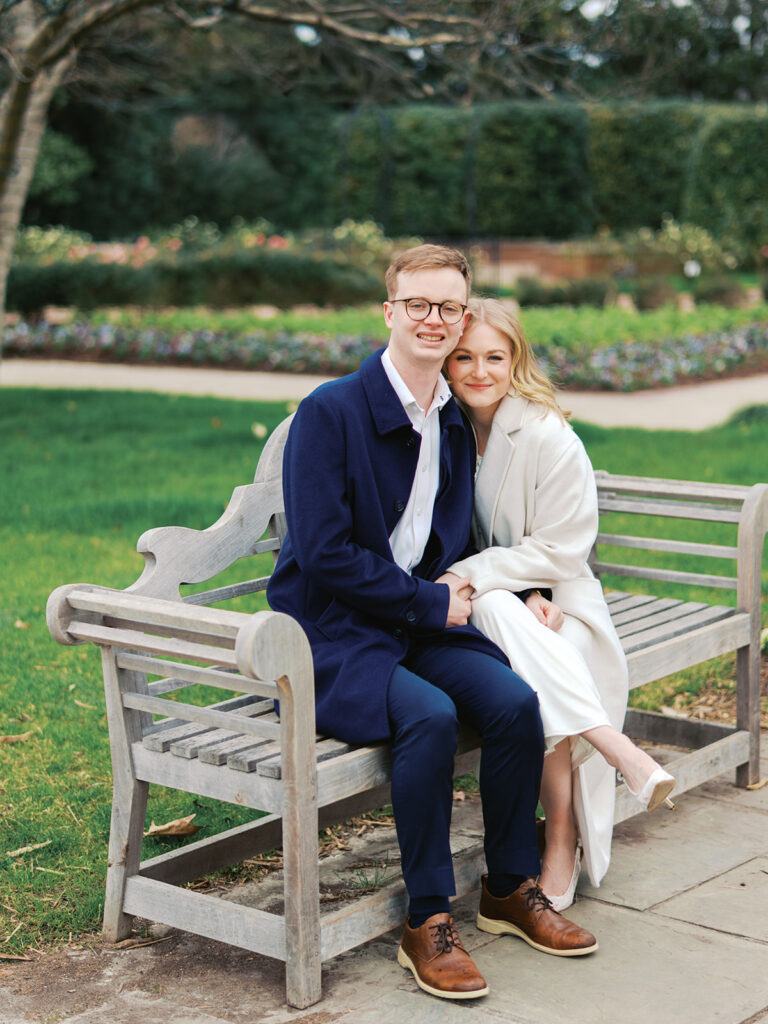 Sierra and Liam walking together during their Dallas Arboretum engagement photos