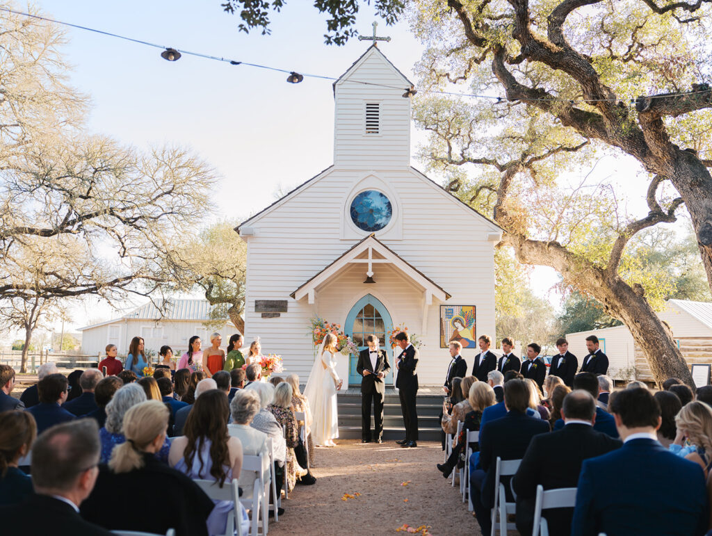 Colorful outdoor wedding ceremony at Rancho Pillow Round Top Texas