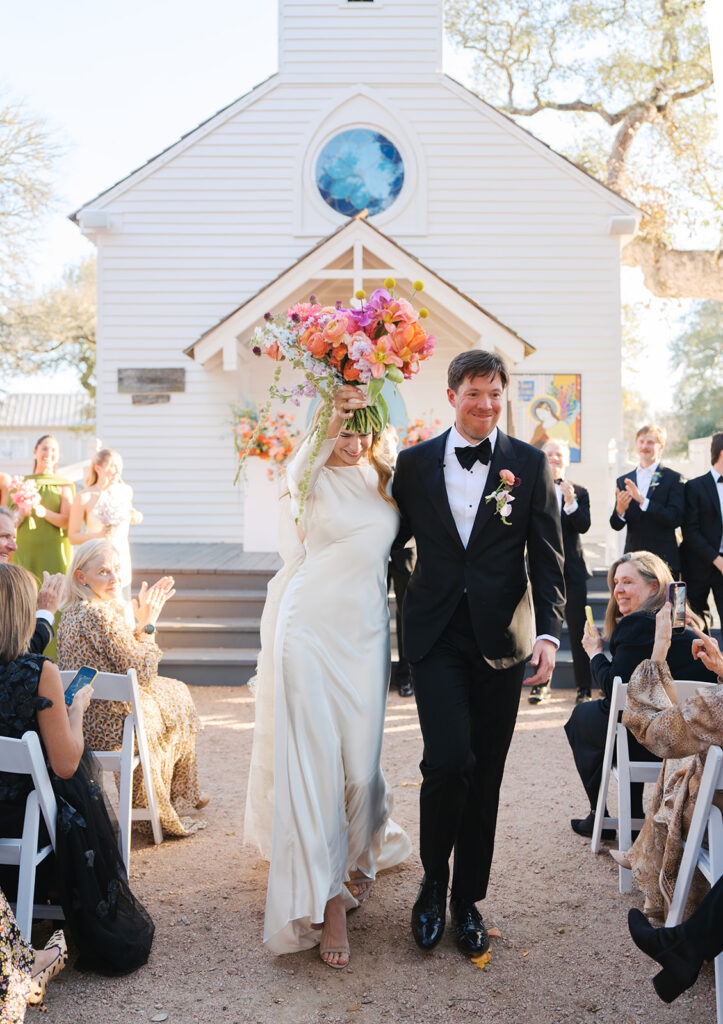 Colorful outdoor wedding ceremony at Rancho Pillow Round Top Texas