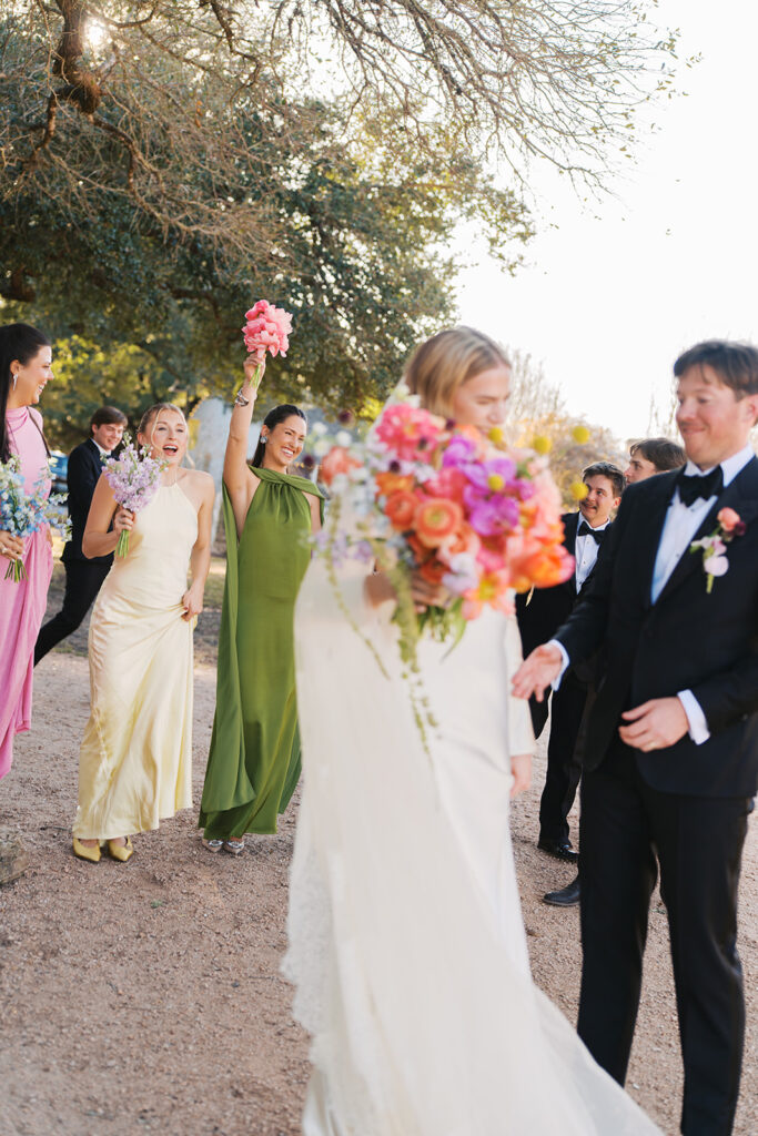 Colorful outdoor wedding ceremony at Rancho Pillow Round Top Texas