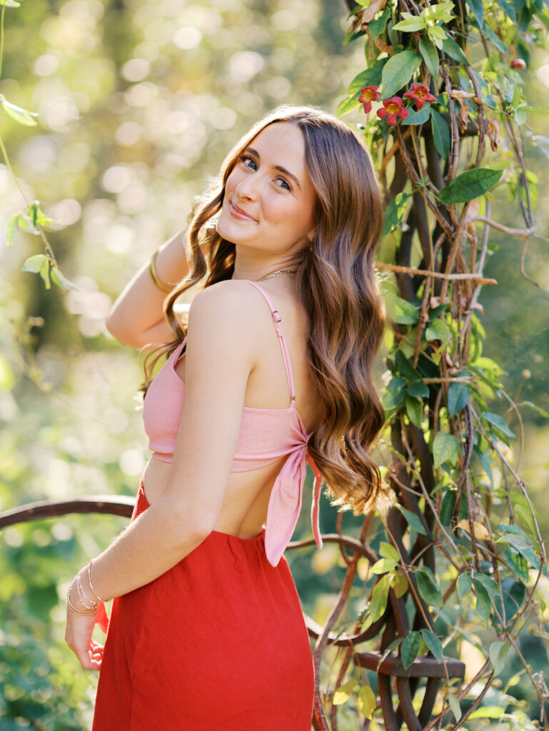 Austin senior portraits on film at Zilker Botanical Garden with Lily surrounded by lush greenery
