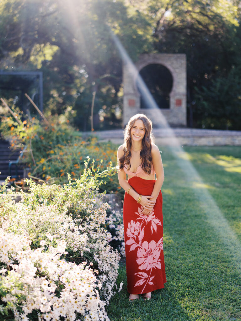 Austin senior portraits on film at Zilker Botanical Garden with Lily surrounded by lush greenery