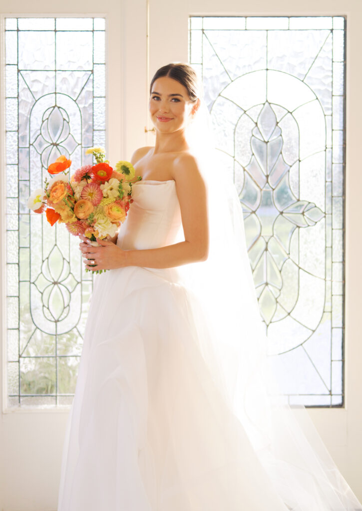 Film bridal portrait of bride walking through flowers at The Grand Lady Austin spring session