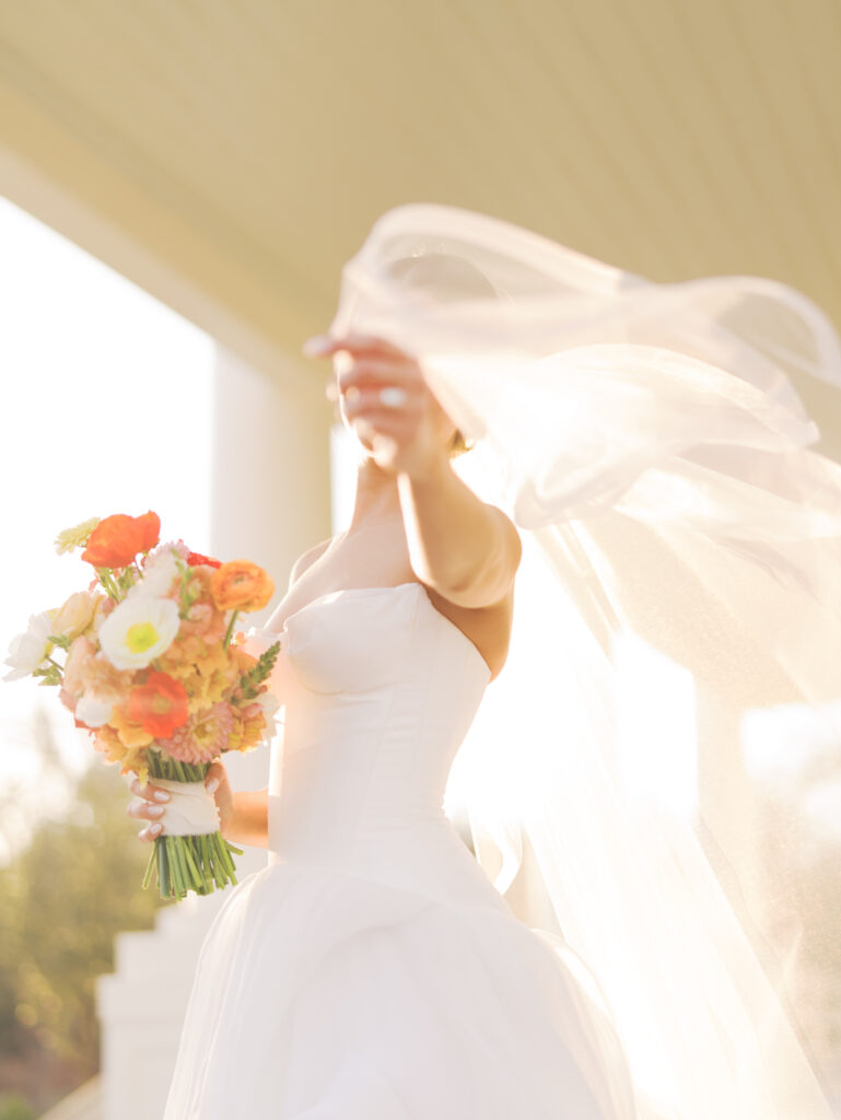 Film bridal portrait of bride walking through flowers at The Grand Lady Austin spring session