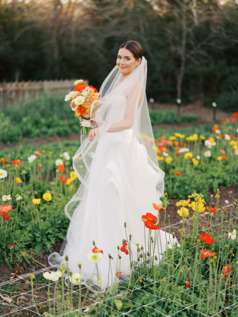 Film bridal portrait of bride walking through flowers at The Grand Lady Austin spring session