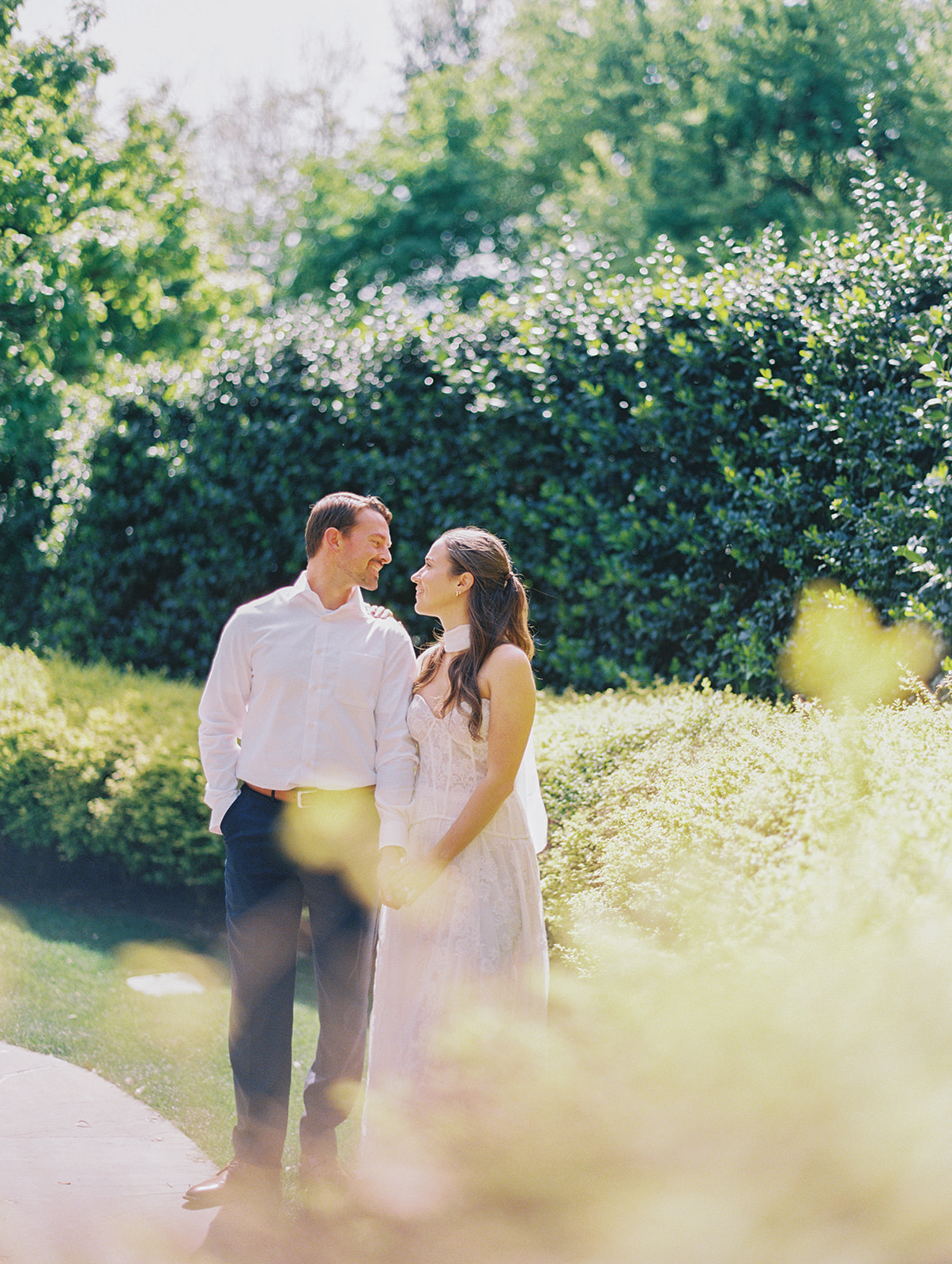 Colorful Dallas Arboretum engagement photos with blooming gardens and sunshine