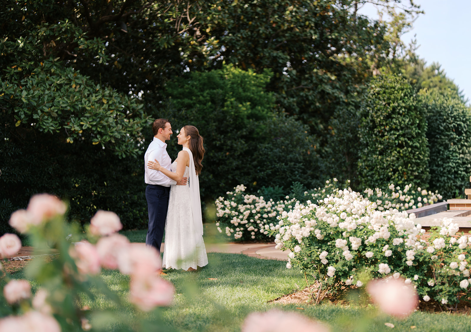 Sunny Dallas Arboretum engagement photos with dreamy film tones and flowers