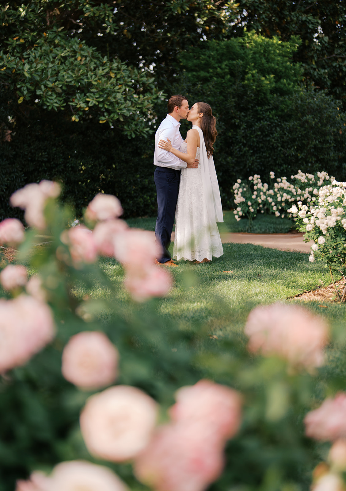 Sunny Dallas Arboretum engagement photos with dreamy film tones and flowers
