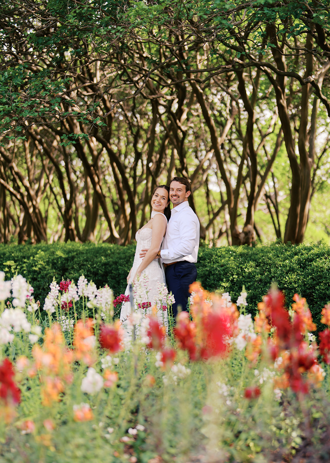 Sunny Dallas Arboretum engagement photos with dreamy film tones and flowers
