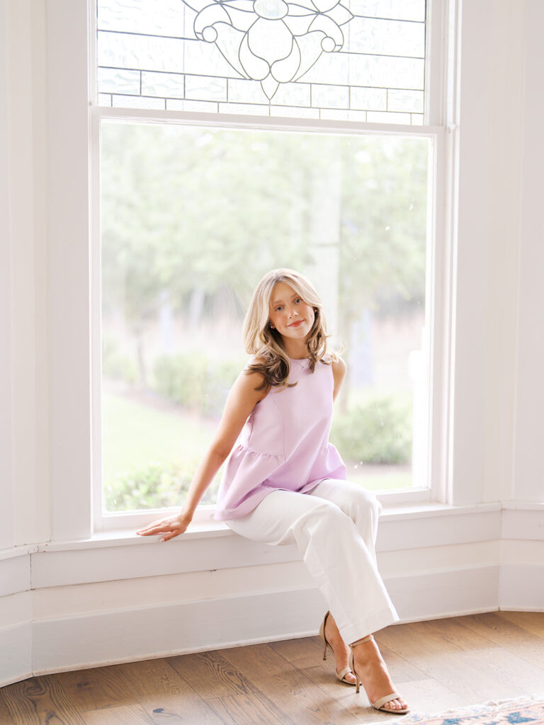 Film senior session with soft sunshine and white architecture at The Grand Lady