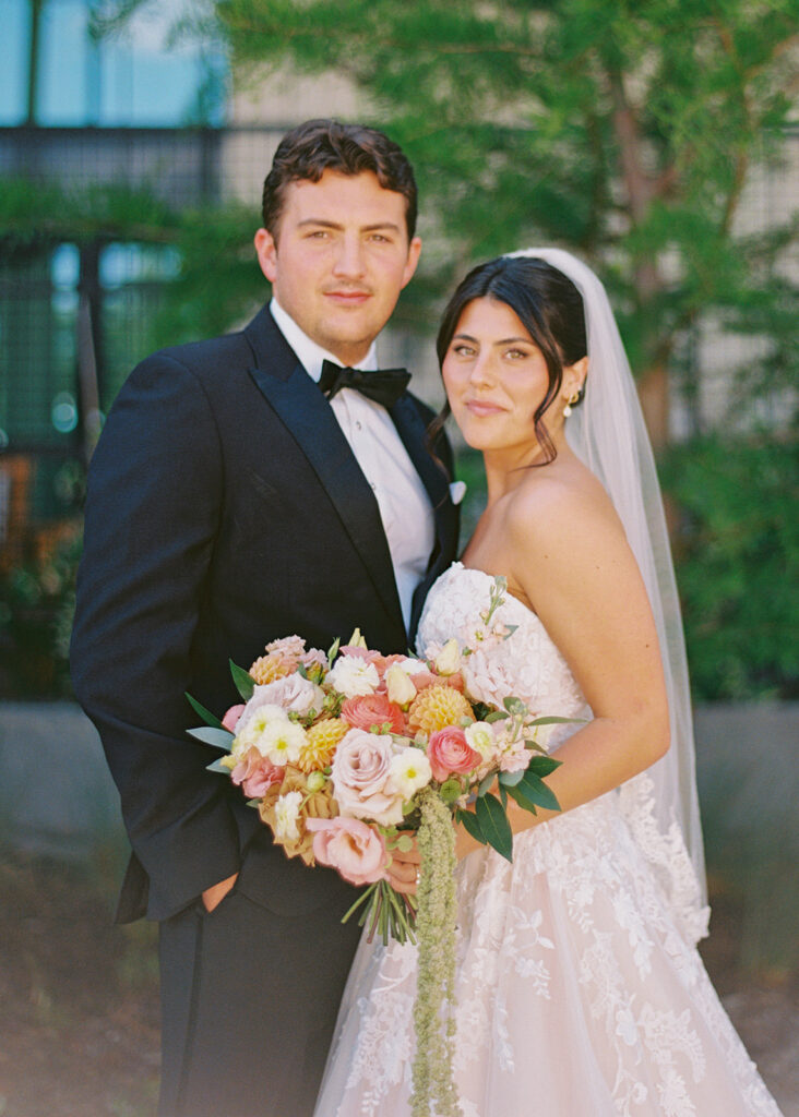 Bride and groom sharing romantic wedding portraits at Horseshoe Bay Resort surrounded by sunshine and stunning Lake LBJ scenery.