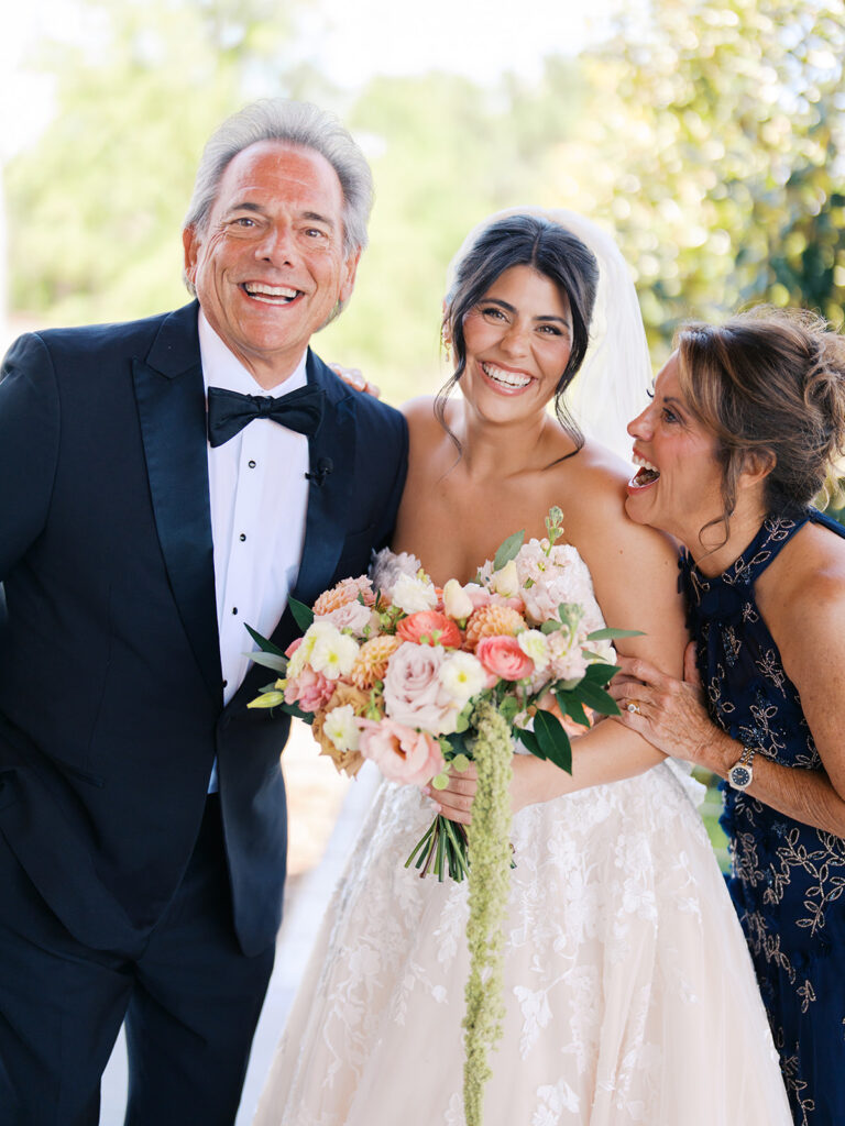Bride and groom sharing romantic wedding portraits at Horseshoe Bay Resort surrounded by sunshine and stunning Lake LBJ scenery.
