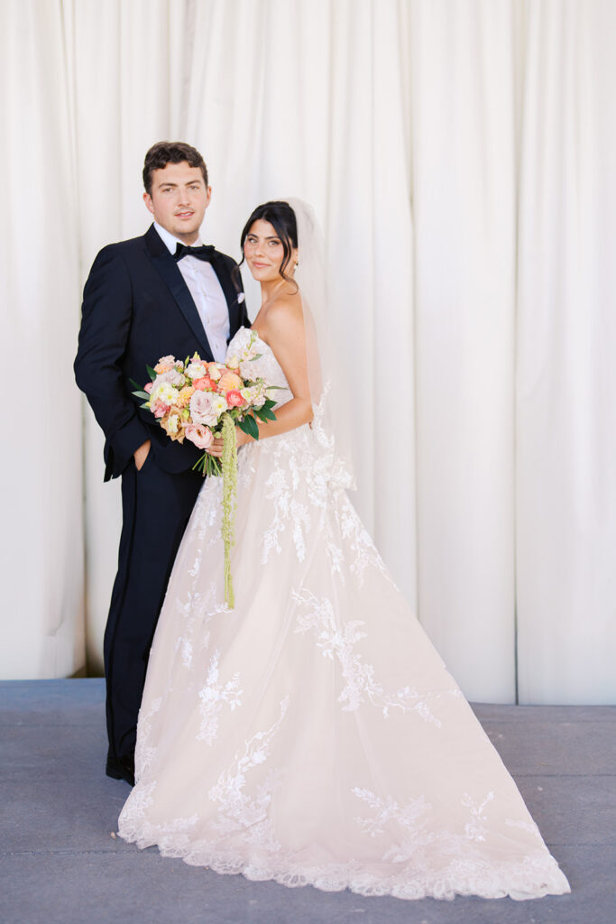 Bride and groom sharing romantic wedding portraits at Horseshoe Bay Resort surrounded by sunshine and stunning Lake LBJ scenery.