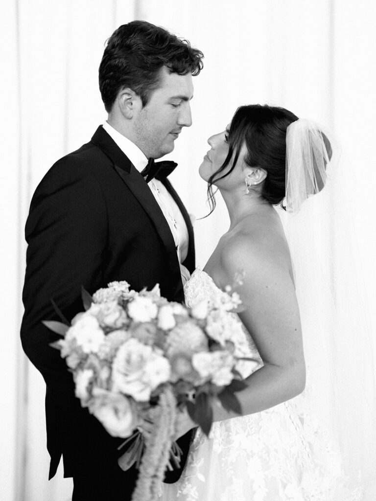 Bride and groom sharing romantic wedding portraits at Horseshoe Bay Resort surrounded by sunshine and stunning Lake LBJ scenery.