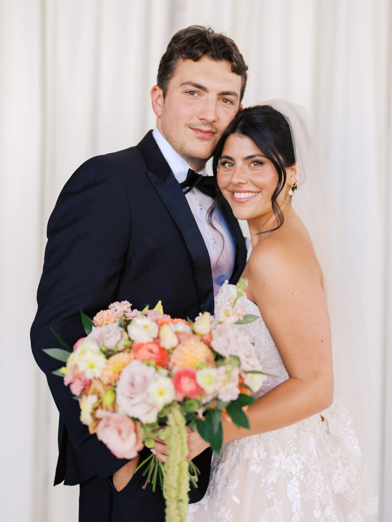 Bride and groom sharing romantic wedding portraits at Horseshoe Bay Resort surrounded by sunshine and stunning Lake LBJ scenery.