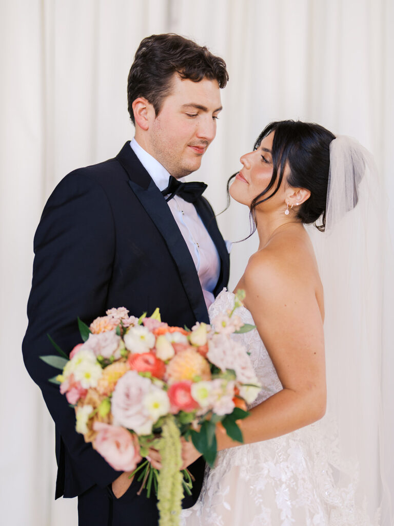 Bride and groom sharing romantic wedding portraits at Horseshoe Bay Resort surrounded by sunshine and stunning Lake LBJ scenery.