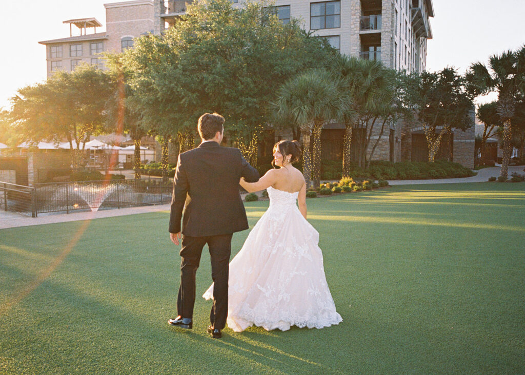 Bride and groom sharing romantic wedding portraits at Horseshoe Bay Resort surrounded by sunshine and stunning Lake LBJ scenery.