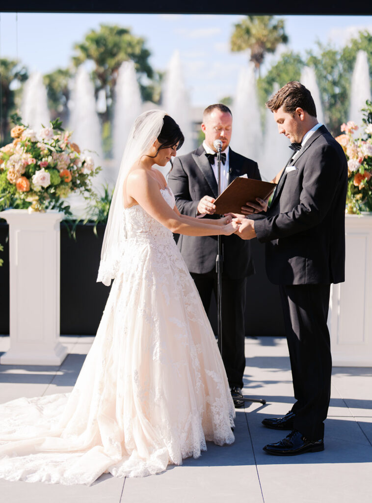 Bride and groom exchanging vows during an outdoor Horseshoe Bay Resort wedding ceremony with beautiful Texas waterfront views