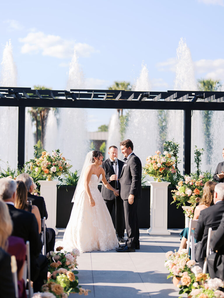 Bride and groom exchanging vows during an outdoor Horseshoe Bay Resort wedding ceremony with beautiful Texas waterfront views
