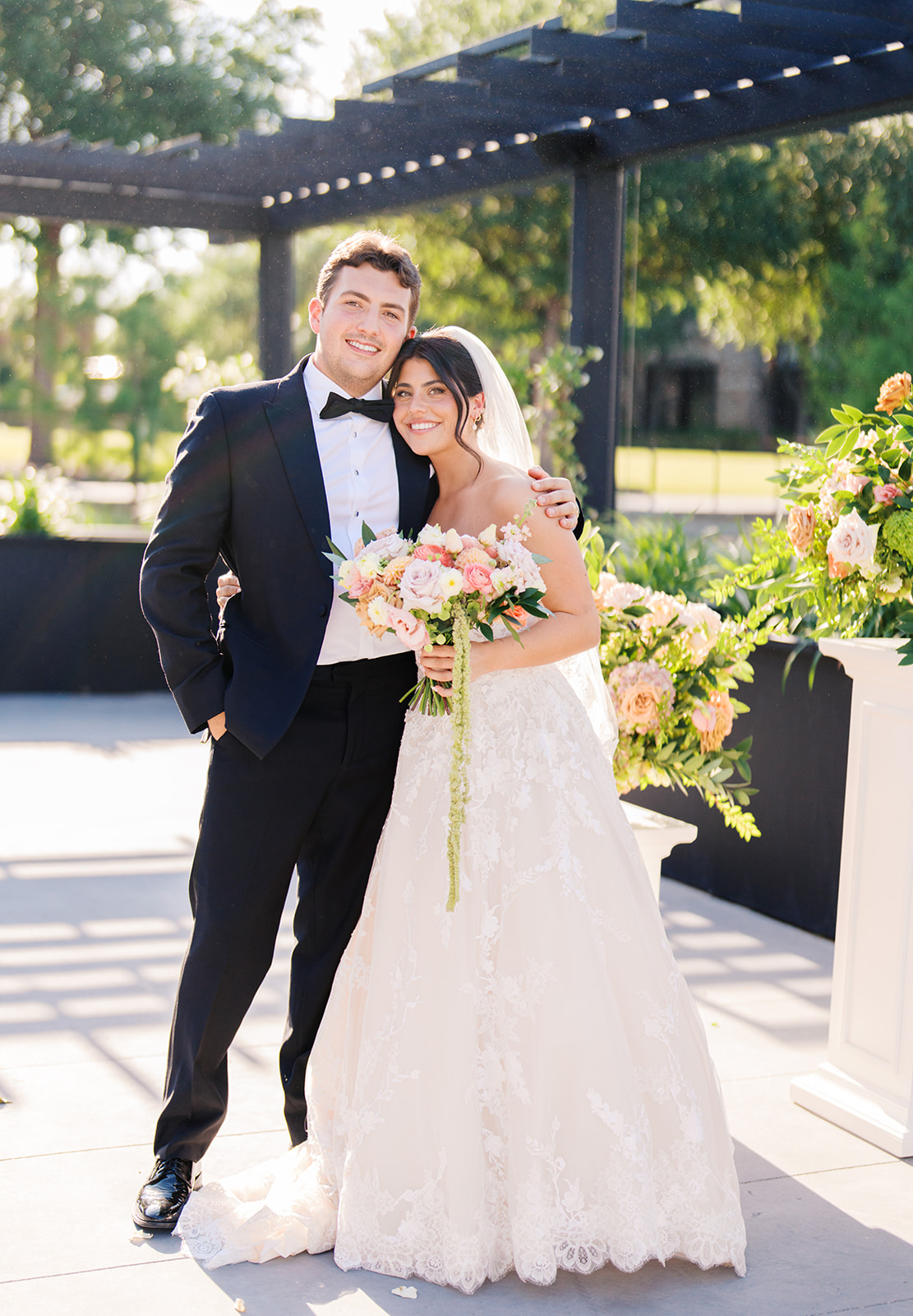 Bride and groom sharing romantic wedding portraits at Horseshoe Bay Resort surrounded by sunshine and stunning Lake LBJ scenery.