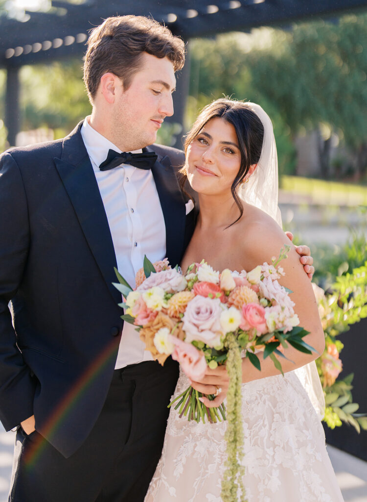 Bride and groom sharing romantic wedding portraits at Horseshoe Bay Resort surrounded by sunshine and stunning Lake LBJ scenery.