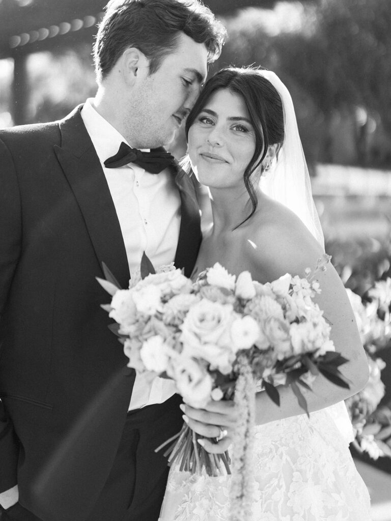 Bride and groom sharing romantic wedding portraits at Horseshoe Bay Resort surrounded by sunshine and stunning Lake LBJ scenery.