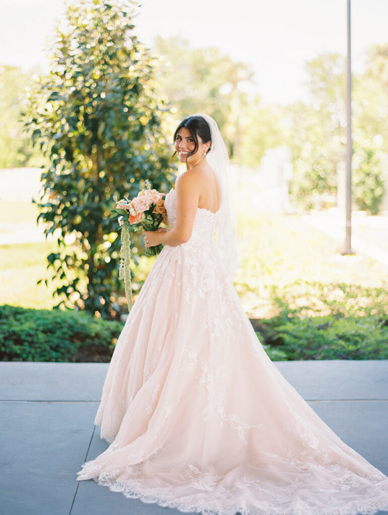 Bride and groom sharing romantic wedding portraits at Horseshoe Bay Resort surrounded by sunshine and stunning Lake LBJ scenery.