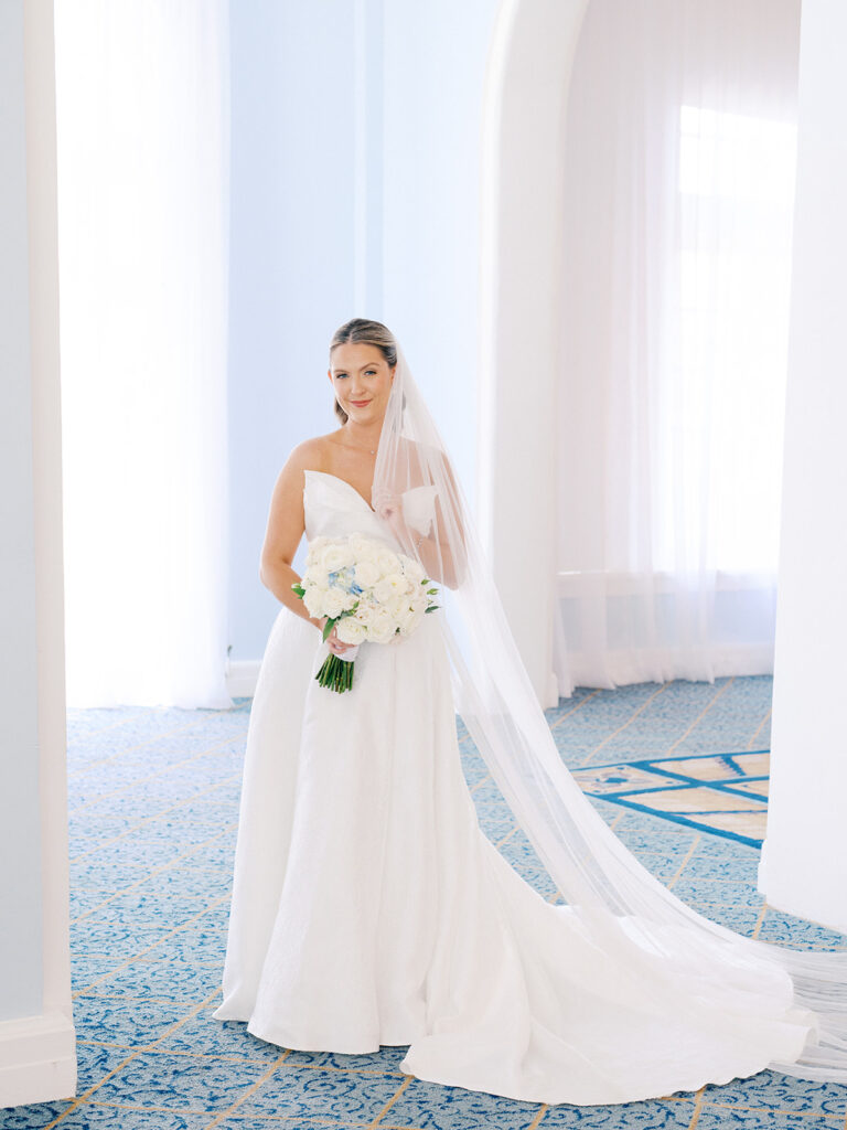 Bride getting ready with her bridesmaids before her elegant wedding at the Grand Galvez in Galveston, Texas.