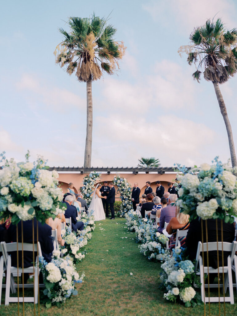 Bride and groom exchanging vows during a beautiful wedding ceremony at the Grand Galvez in Galveston, Texas.