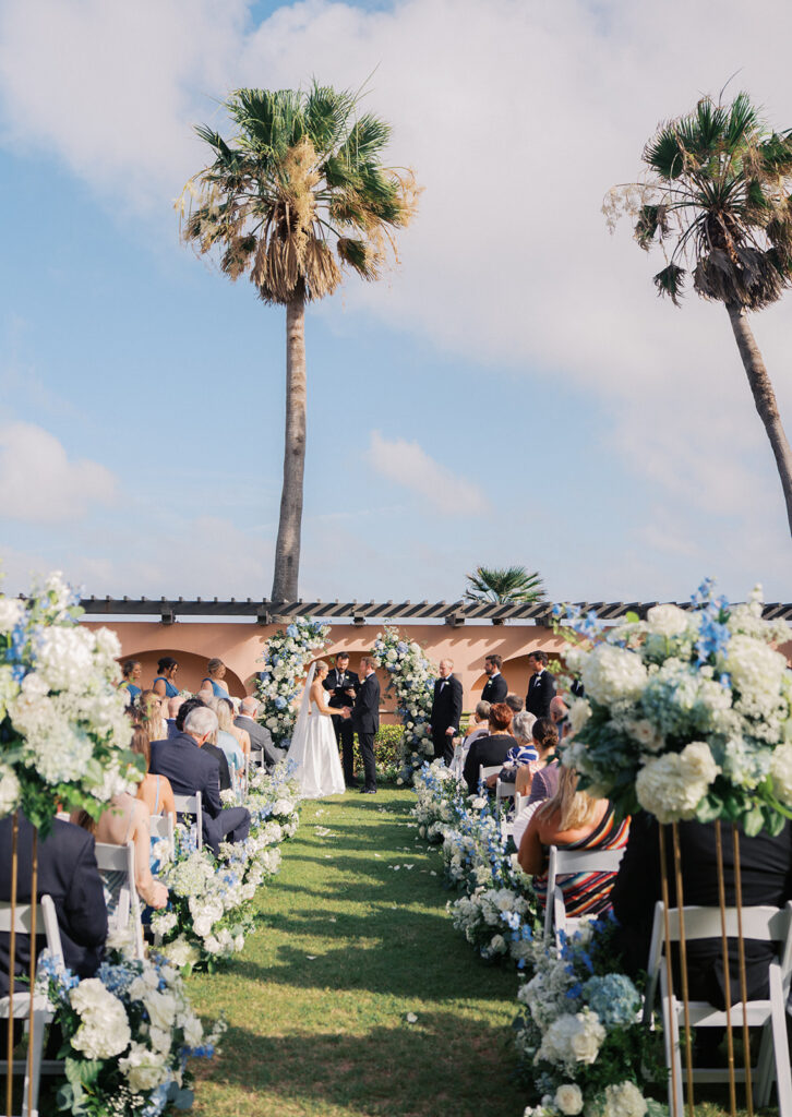 Bride and groom exchanging vows during a beautiful wedding ceremony at the Grand Galvez in Galveston, Texas.