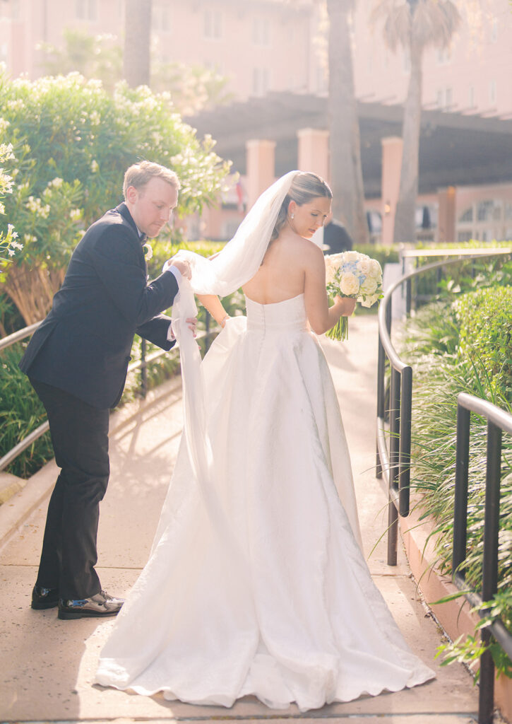 Bride and groom sharing romantic wedding portraits at the Grand Galvez in Galveston, Texas with historic architecture and coastal views