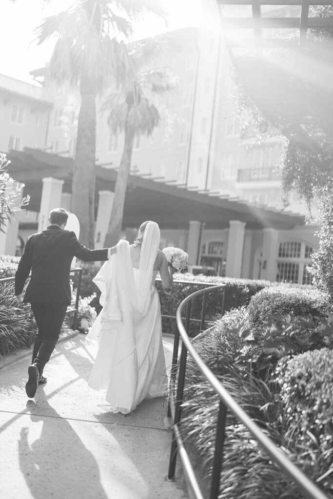 Bride and groom sharing romantic wedding portraits at the Grand Galvez in Galveston, Texas with historic architecture and coastal views