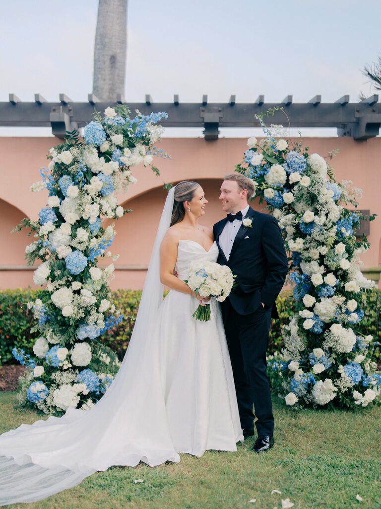 Bride and groom sharing romantic wedding portraits at the Grand Galvez in Galveston, Texas with historic architecture and coastal views