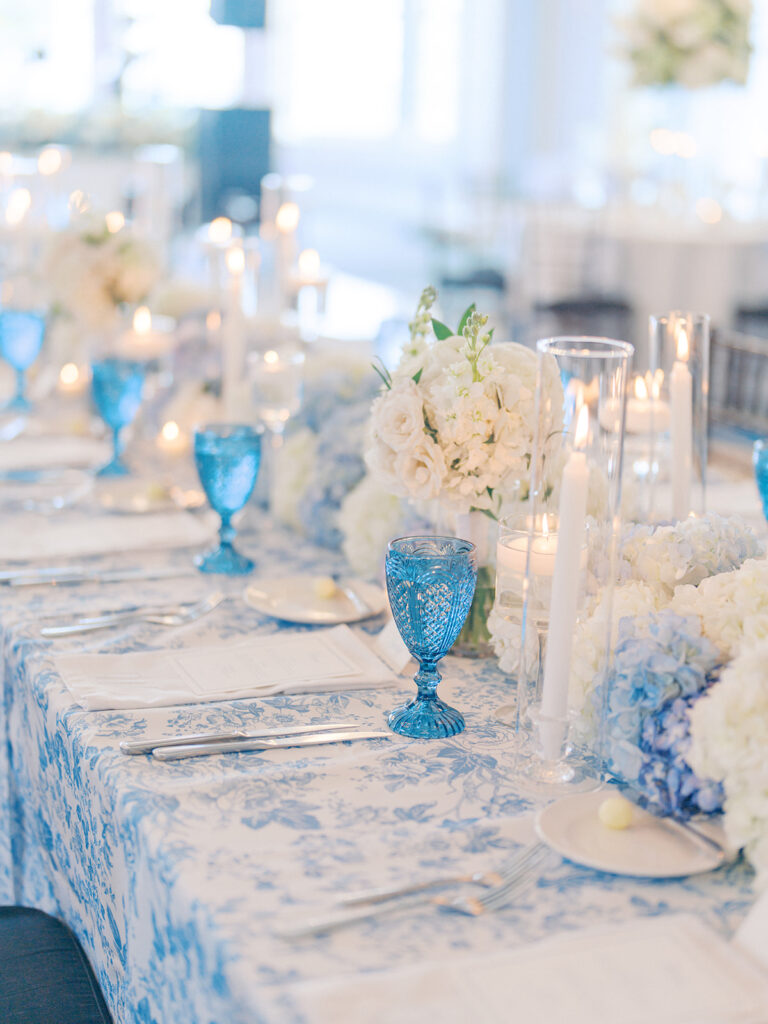 Elegant wedding reception at the Grand Galvez in Galveston, Texas featuring lush florals, soft blue details, and joyful celebration