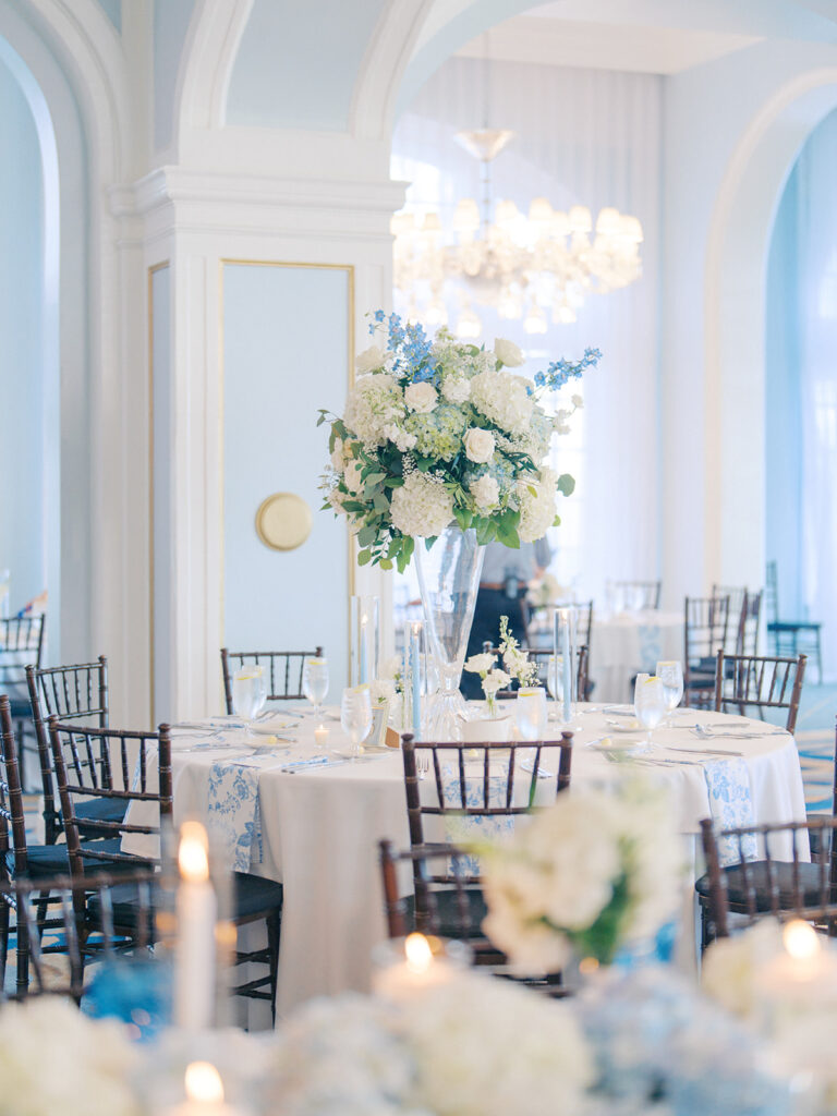 Elegant wedding reception at the Grand Galvez in Galveston, Texas featuring lush florals, soft blue details, and joyful celebration