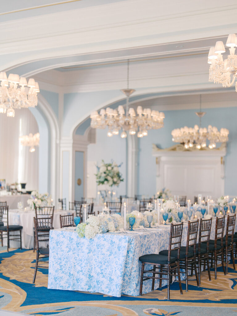 Elegant wedding reception at the Grand Galvez in Galveston, Texas featuring lush florals, soft blue details, and joyful celebration