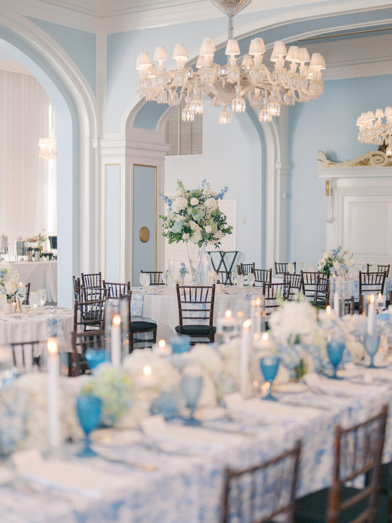 Elegant wedding reception at the Grand Galvez in Galveston, Texas featuring lush florals, soft blue details, and joyful celebration