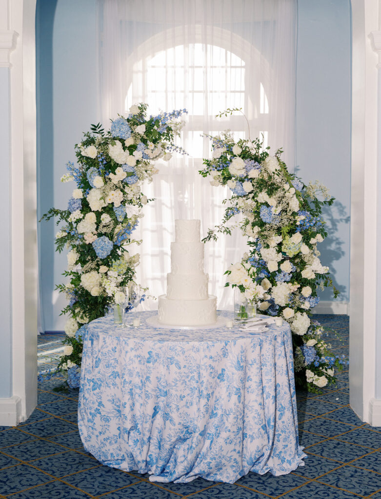 Elegant wedding reception at the Grand Galvez in Galveston, Texas featuring lush florals, soft blue details, and joyful celebration