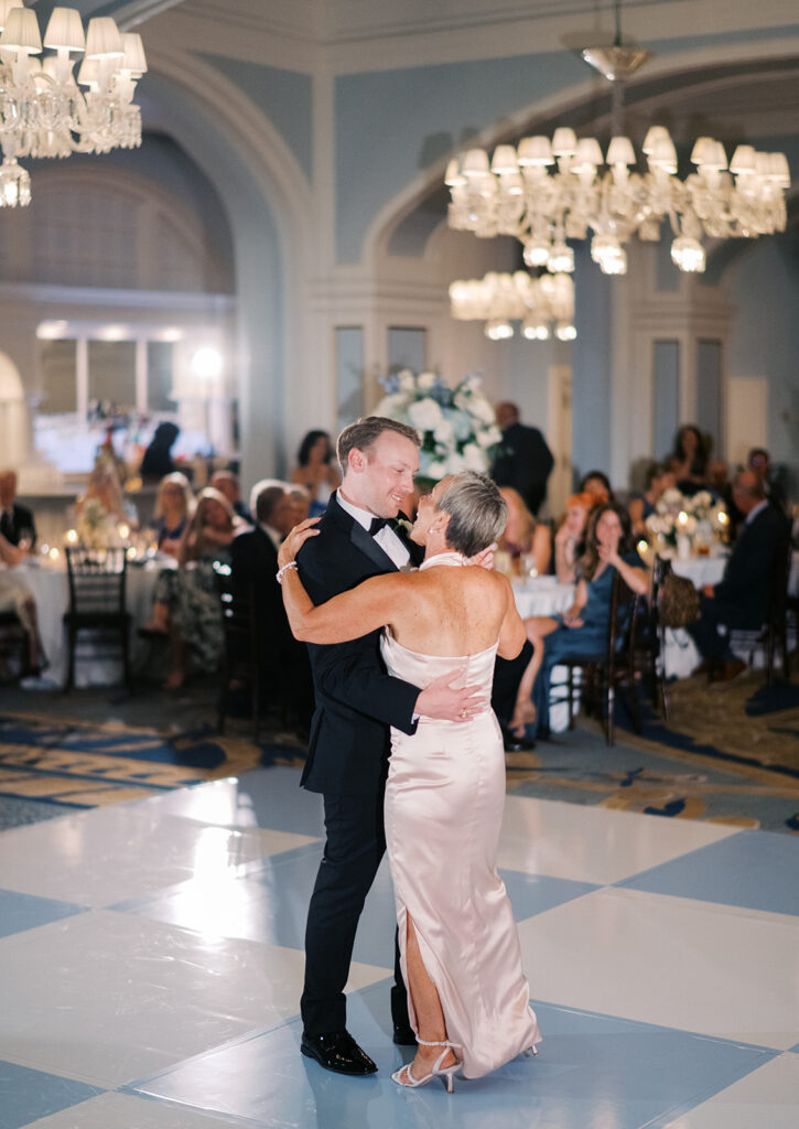 Elegant wedding reception at the Grand Galvez in Galveston, Texas featuring lush florals, soft blue details, and joyful celebration