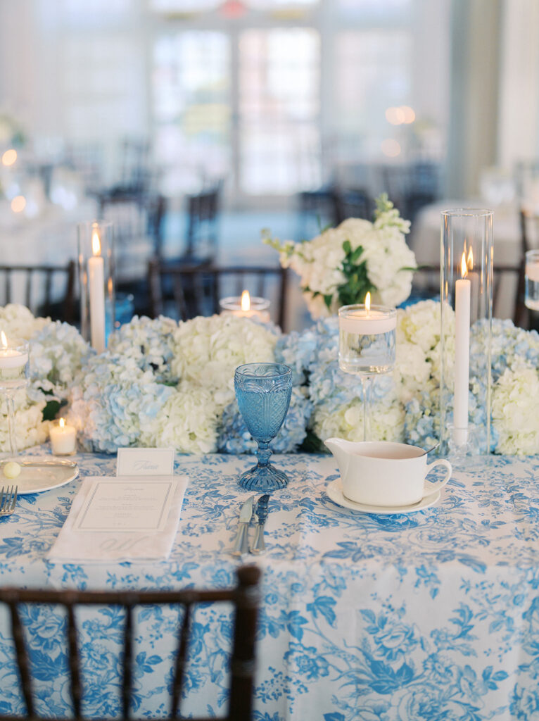Elegant wedding reception at the Grand Galvez in Galveston, Texas featuring lush florals, soft blue details, and joyful celebration