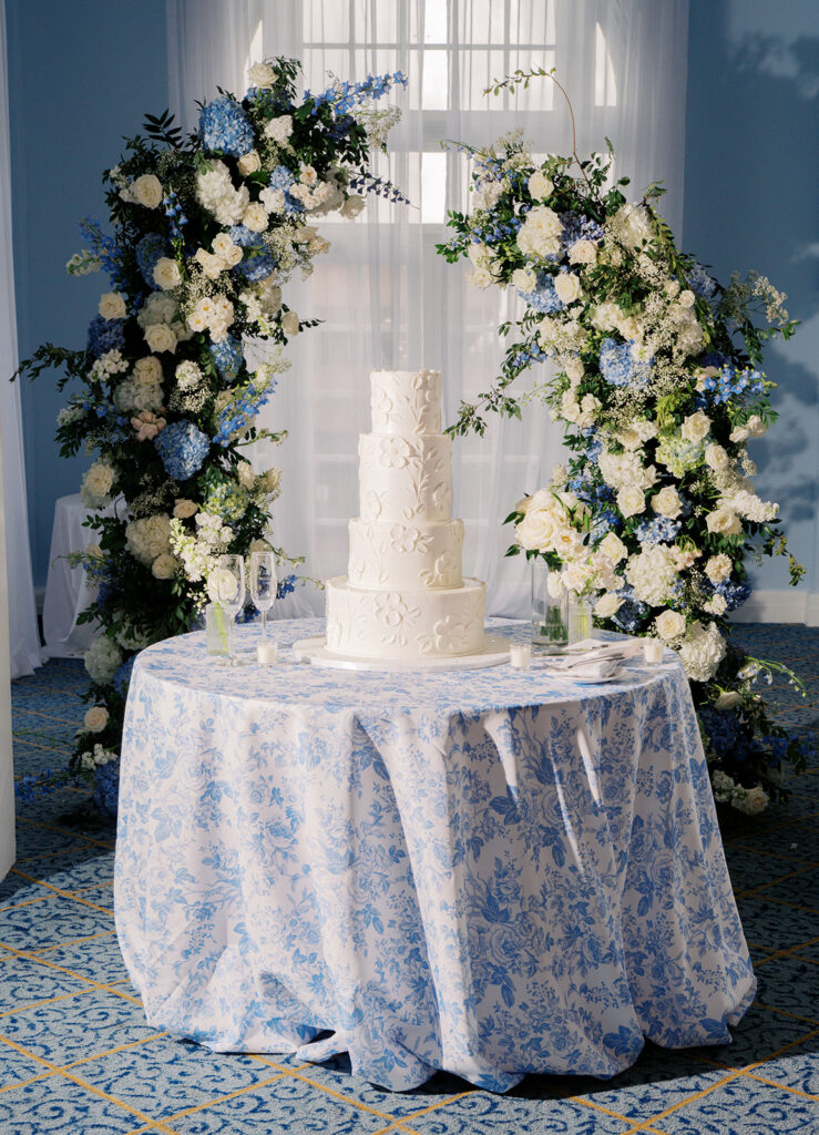 Elegant wedding reception at the Grand Galvez in Galveston, Texas featuring lush florals, soft blue details, and joyful celebration