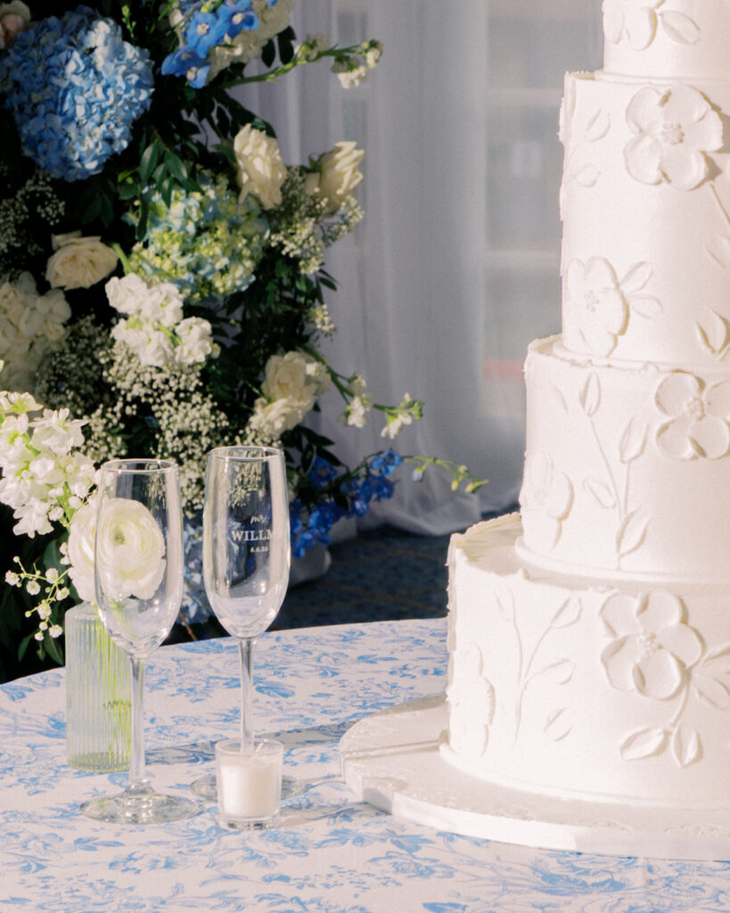 Elegant wedding reception at the Grand Galvez in Galveston, Texas featuring lush florals, soft blue details, and joyful celebration