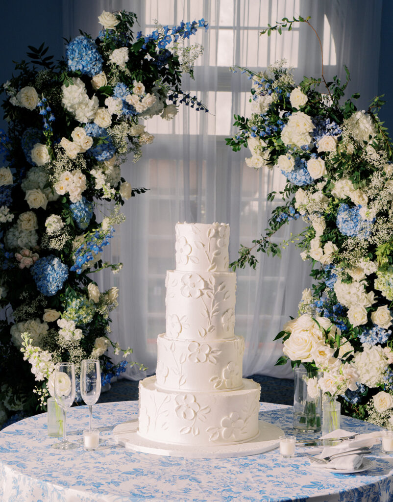 Elegant wedding reception at the Grand Galvez in Galveston, Texas featuring lush florals, soft blue details, and joyful celebration