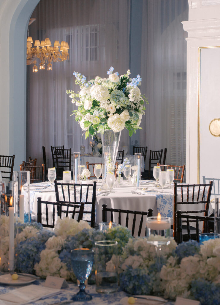 Elegant wedding reception at the Grand Galvez in Galveston, Texas featuring lush florals, soft blue details, and joyful celebration