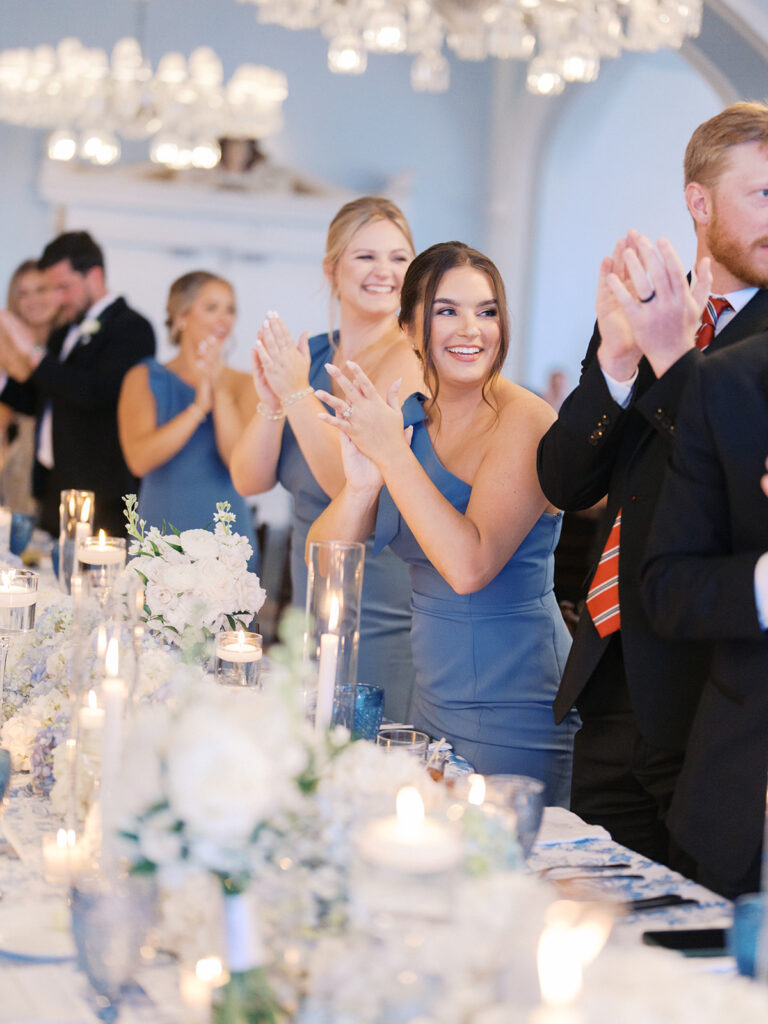 Elegant wedding reception at the Grand Galvez in Galveston, Texas featuring lush florals, soft blue details, and joyful celebration