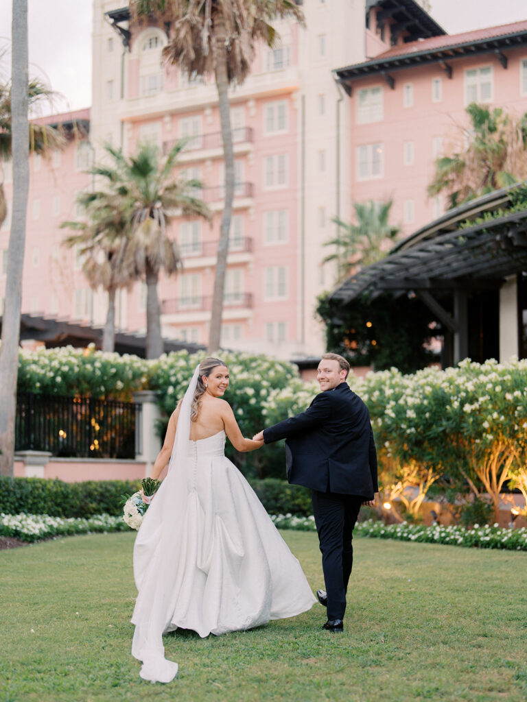 Bride and groom sharing romantic wedding portraits at the Grand Galvez in Galveston, Texas with historic architecture and coastal views.