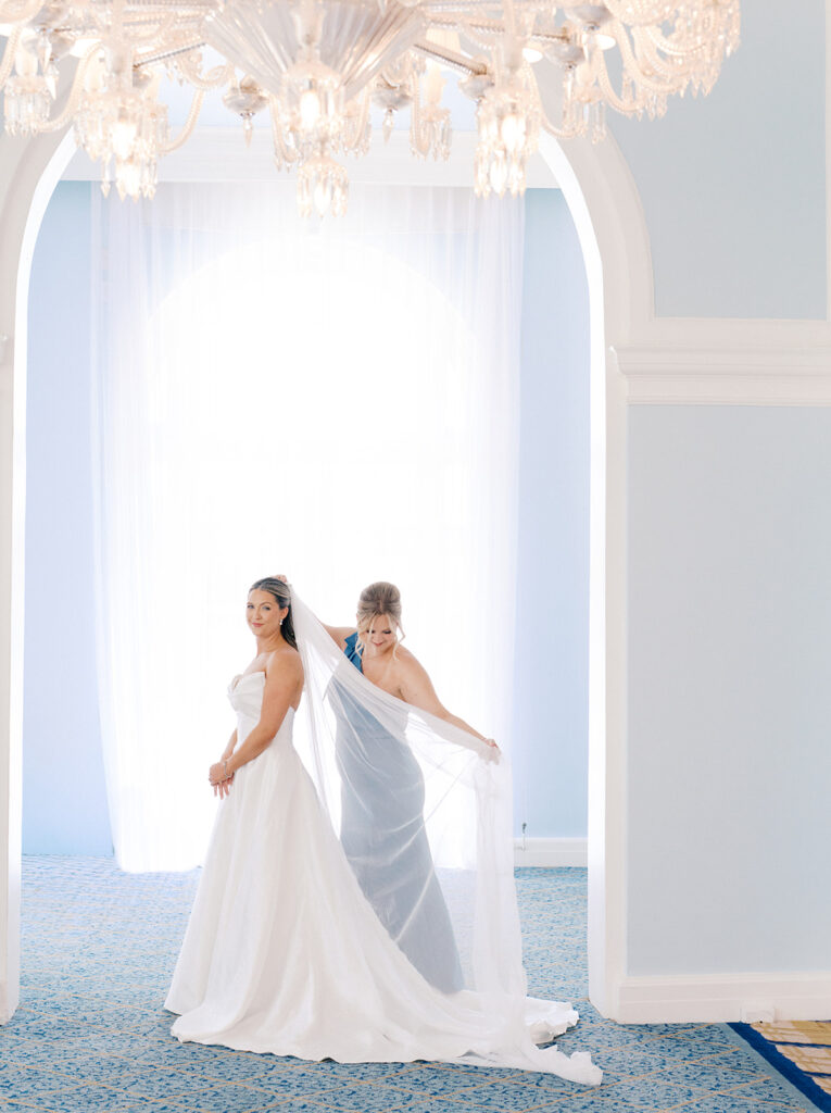Bride getting ready with her bridesmaids before her elegant wedding at the Grand Galvez in Galveston, Texas.