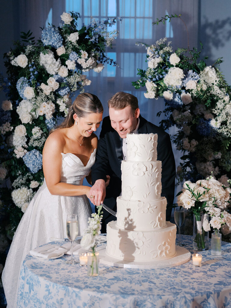Elegant wedding reception at the Grand Galvez in Galveston, Texas featuring lush florals, soft blue details, and joyful celebration