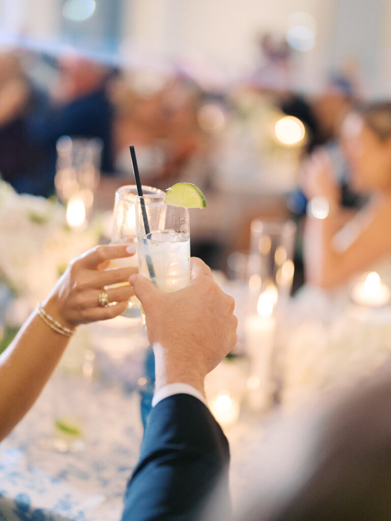 Elegant wedding reception at the Grand Galvez in Galveston, Texas featuring lush florals, soft blue details, and joyful celebration
